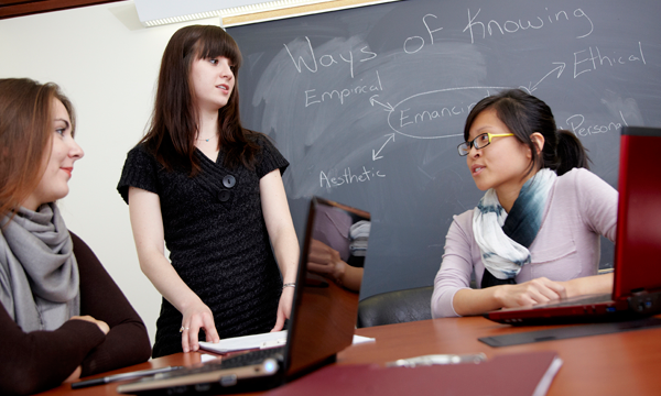 3 students talking in a group study room