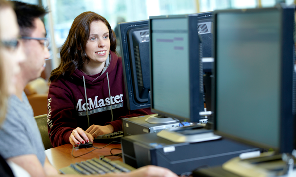 A student looking at a desktop computer