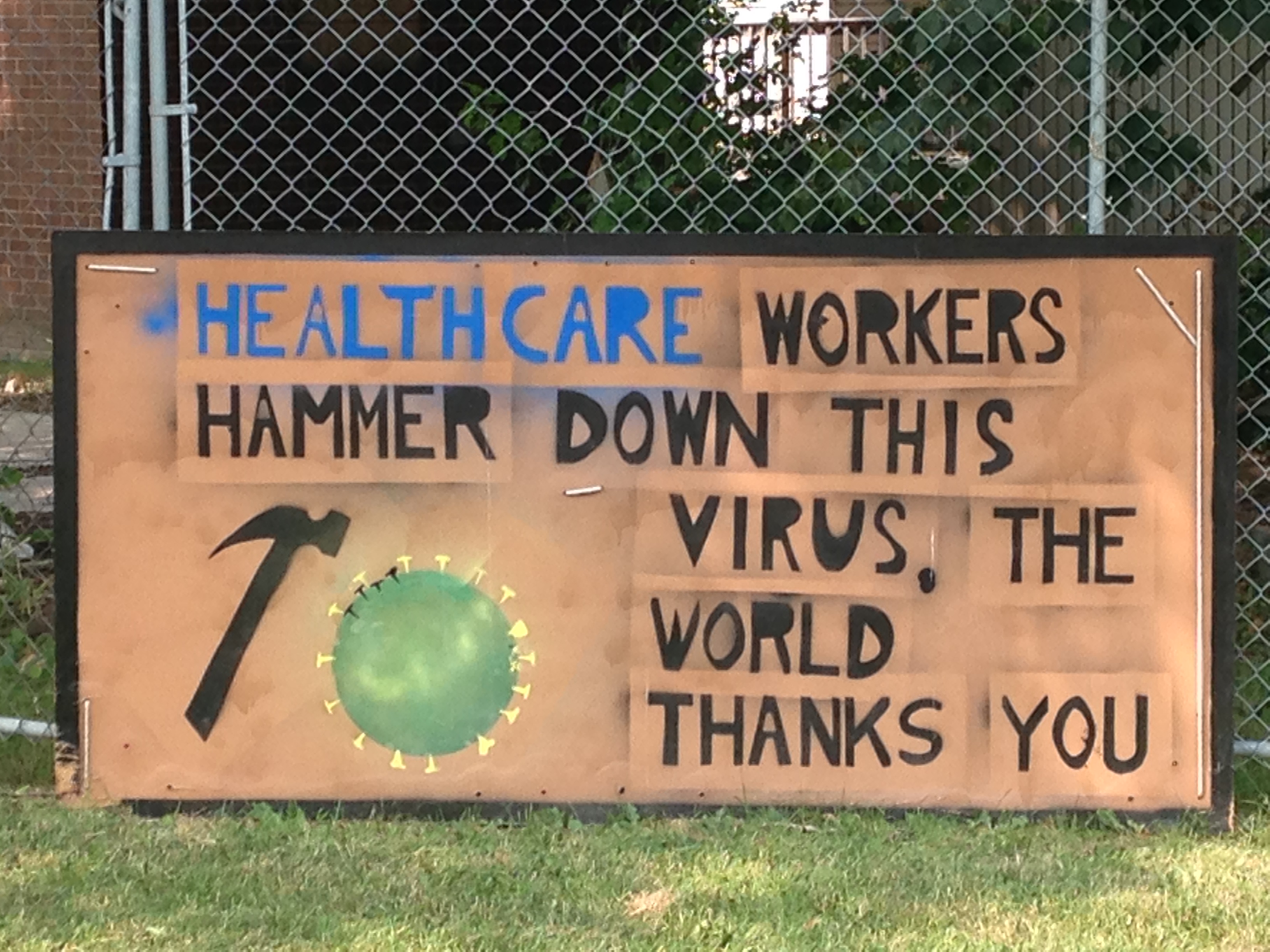 A sign reads “healthcare workers hammer down this virus. The world thanks you."